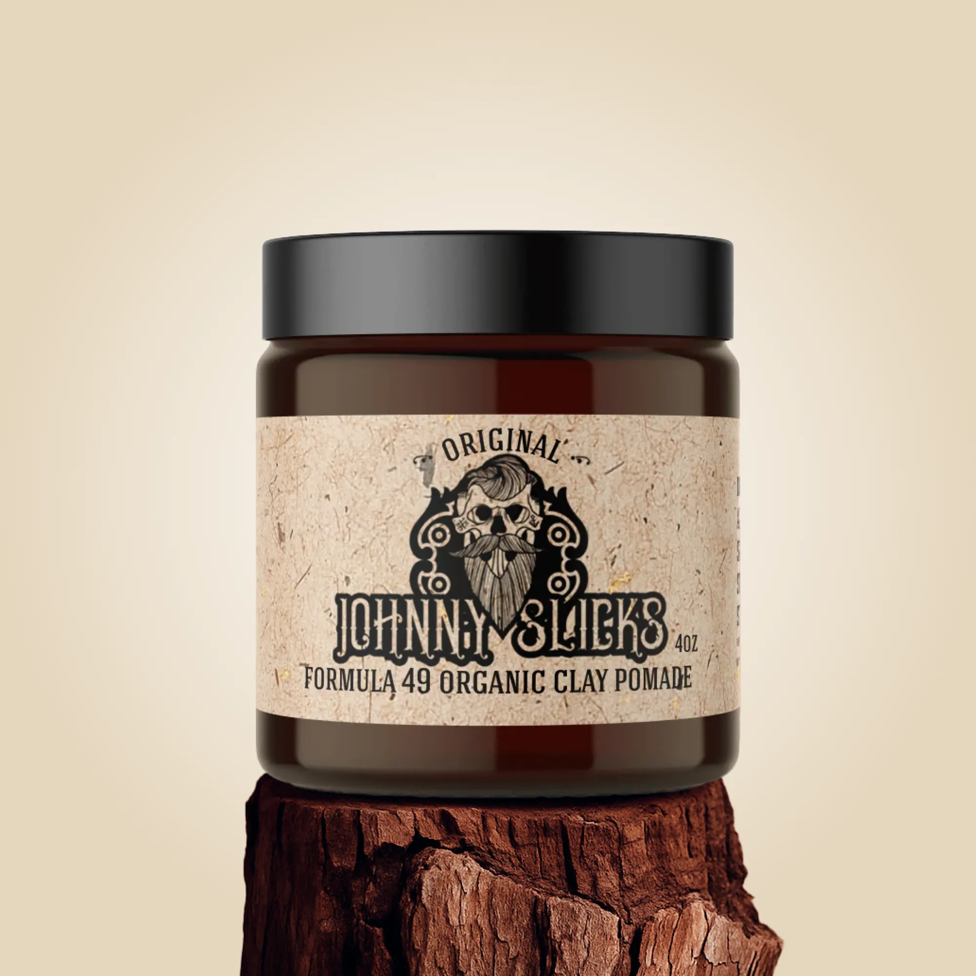 Jar of Johnny Slicks organic clay pomade on a wooden block with a beige background